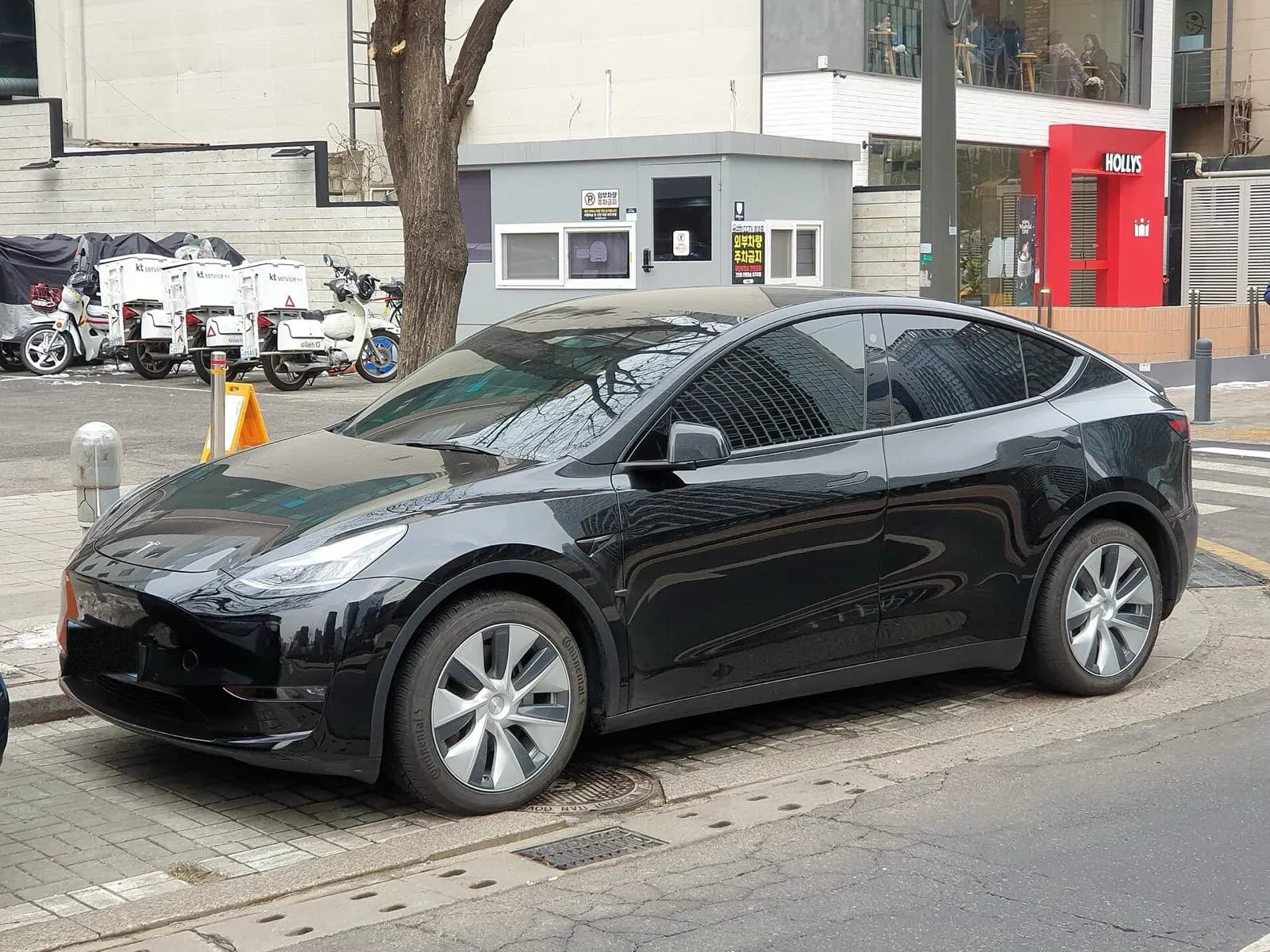 Black Tesla Model Y parked outside a building